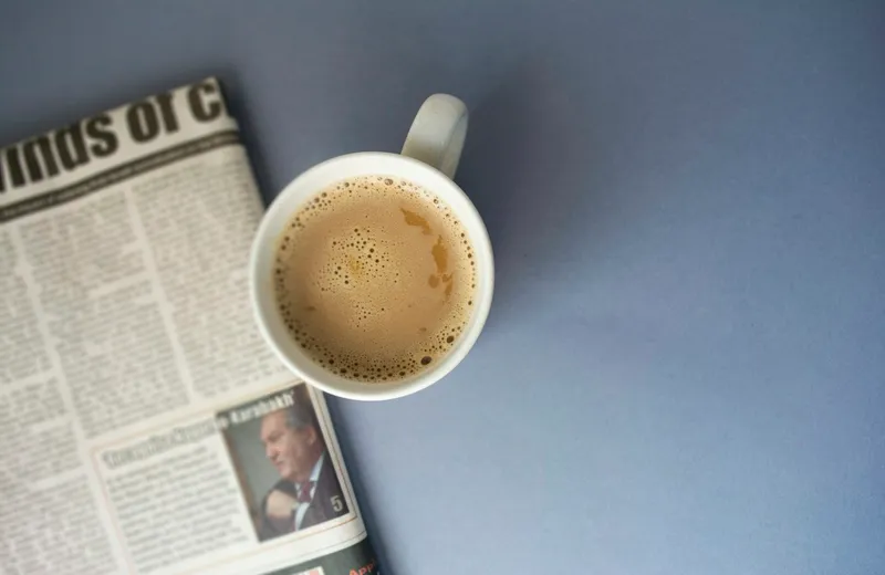 Morning newspaper beside a cup of coffee — ViviMate news